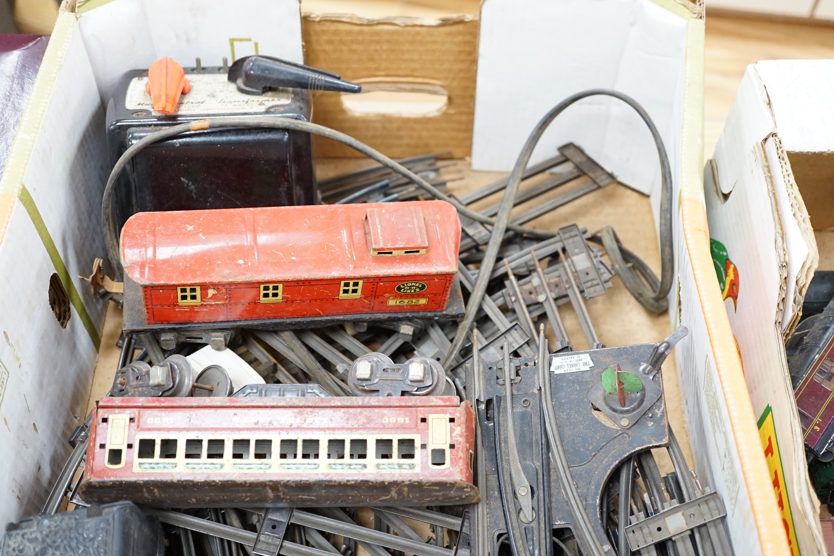 Lionel Lines gauge O tinplate American outline model railway, including seven items of rolling stock together with a quantity of three rail track sections